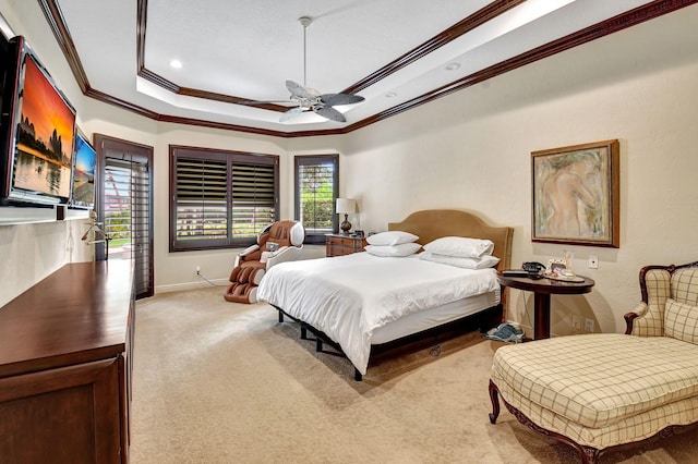 carpeted bedroom with ornamental molding, a raised ceiling, and ceiling fan