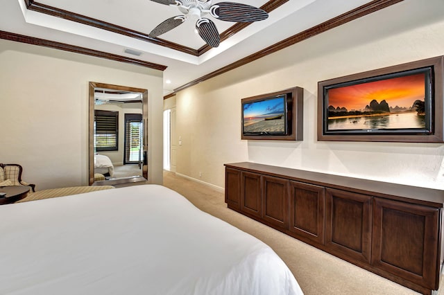 carpeted bedroom with ornamental molding, a raised ceiling, and ceiling fan