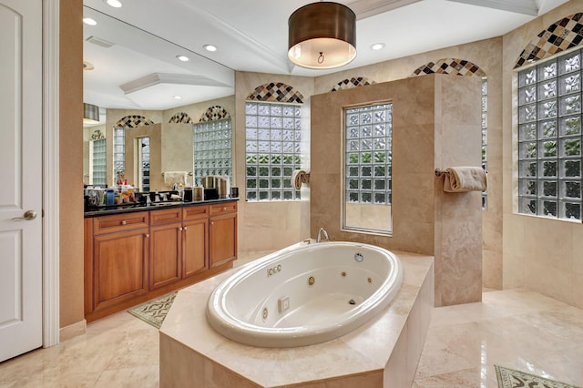 bathroom featuring vanity and tiled bath