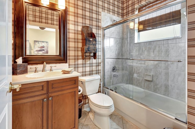 full bathroom with vanity, shower / bath combination with glass door, and toilet