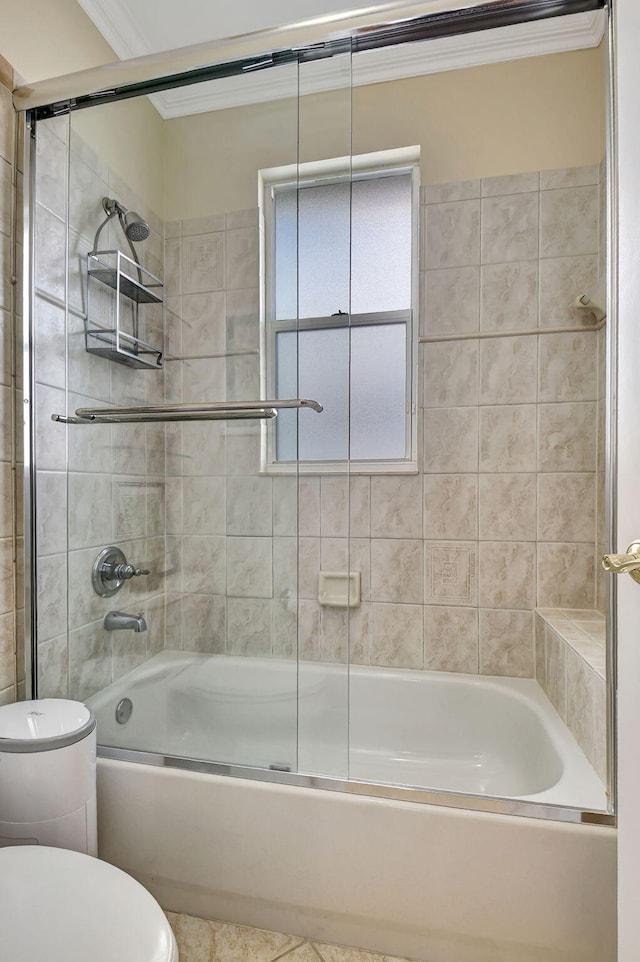 bathroom with toilet, crown molding, and bath / shower combo with glass door