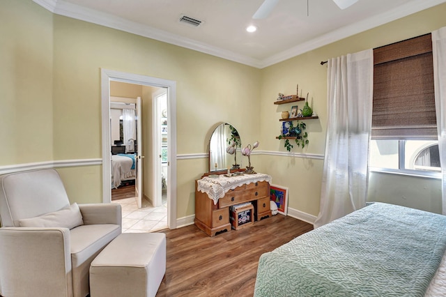 bedroom featuring ornamental molding, hardwood / wood-style flooring, and ceiling fan