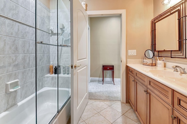 bathroom featuring vanity, bath / shower combo with glass door, and tile patterned flooring