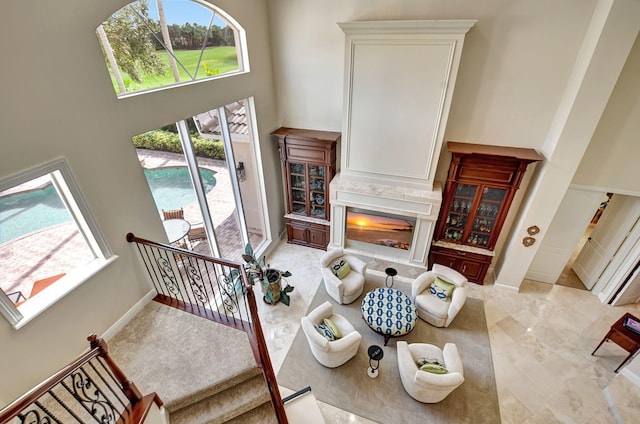 living room featuring a wealth of natural light and a towering ceiling