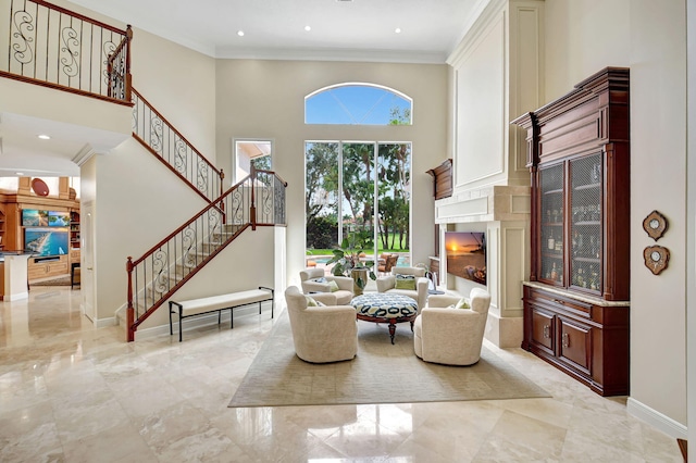 living room featuring ornamental molding and a high ceiling