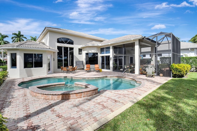 rear view of house featuring a patio, a swimming pool with hot tub, a lawn, and a lanai