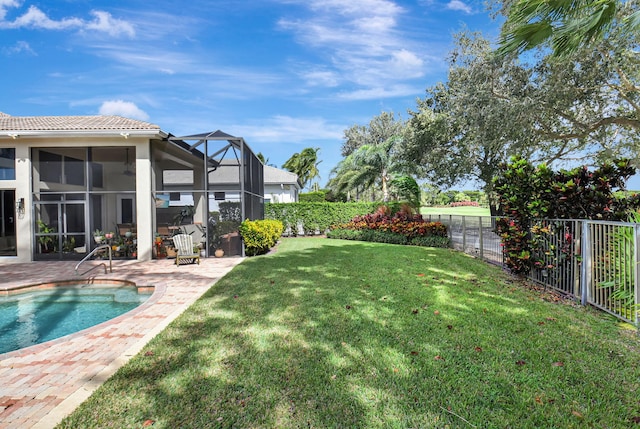 view of yard with a fenced in pool, a patio area, and glass enclosure