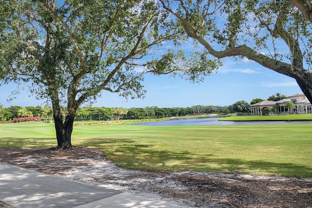 surrounding community featuring a yard and a water view