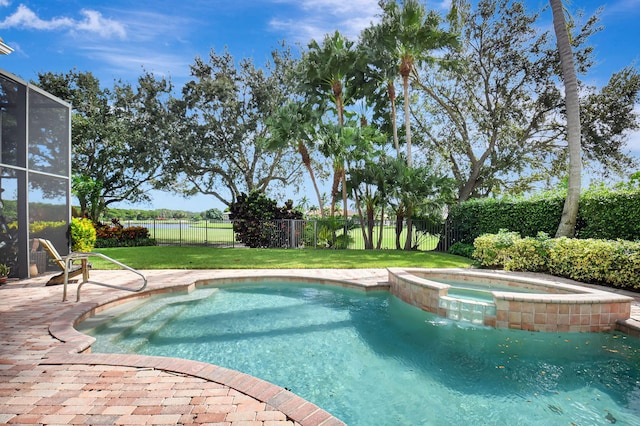 view of swimming pool with an in ground hot tub, a yard, and glass enclosure