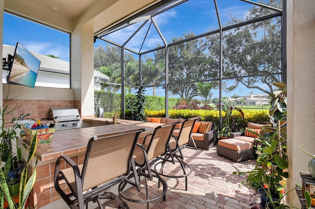 view of patio featuring a bar, area for grilling, a grill, and a lanai