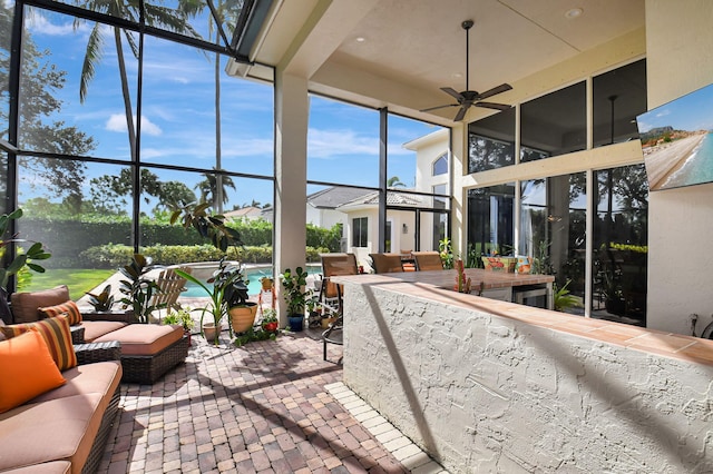 sunroom / solarium featuring ceiling fan