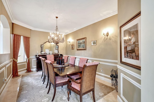 dining space with crown molding and a chandelier