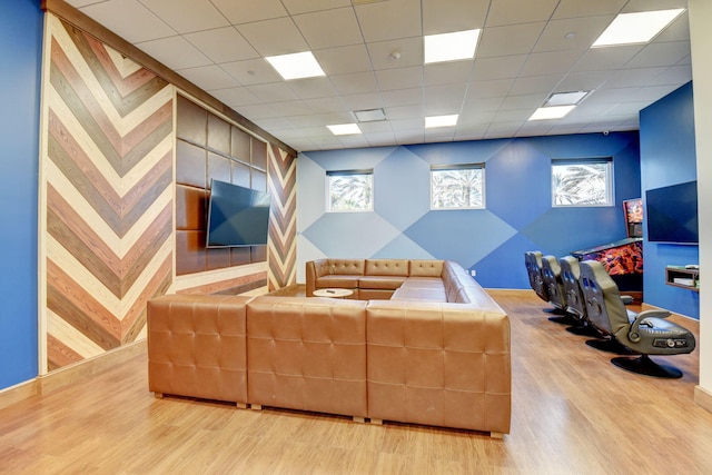 living room featuring hardwood / wood-style floors and a paneled ceiling