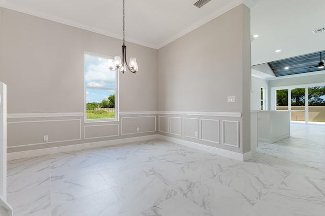 spare room with crown molding and a notable chandelier