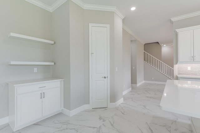 interior space with white cabinetry, backsplash, and ornamental molding