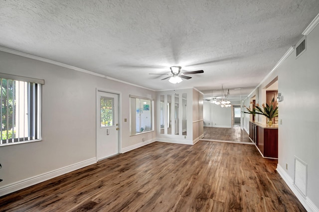 interior space featuring ceiling fan with notable chandelier, dark hardwood / wood-style flooring, a healthy amount of sunlight, and crown molding