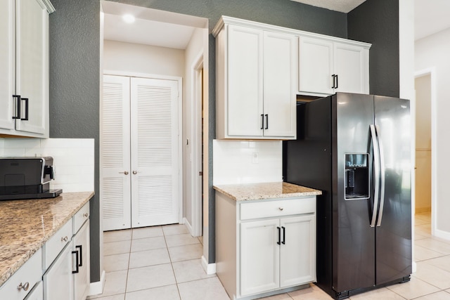 19535 Split Rail Run, Loxahatchee, FL 33470 - kitchen featuring stainless steel refrigerator with ice dispenser, light tile patterned floors, backsplash, and a textured wall
