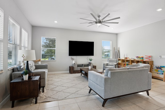 living room with ceiling fan, a healthy amount of sunlight, and light tile patterned floors