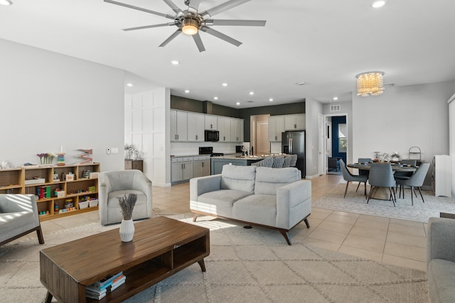 living room featuring ceiling fan and light tile patterned floors