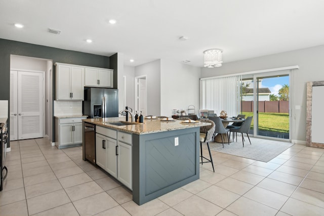 19535 Split Rail Run, Loxahatchee, FL 33470 - kitchen featuring a sink, stainless steel refrigerator with ice dispenser, recessed lighting, light tile patterned floors, and an island with sink