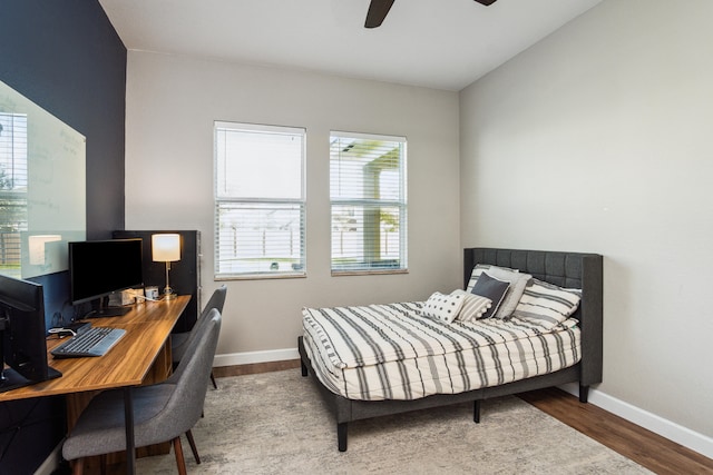 bedroom with multiple windows, hardwood / wood-style floors, and ceiling fan