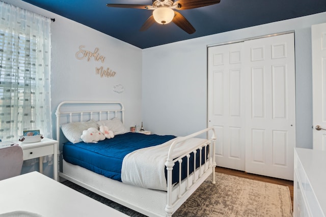 bedroom featuring hardwood / wood-style flooring, ceiling fan, and a closet