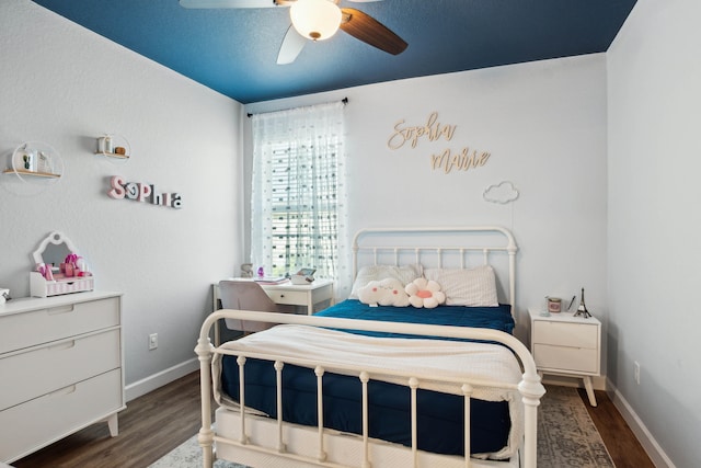 bedroom featuring dark hardwood / wood-style flooring and ceiling fan