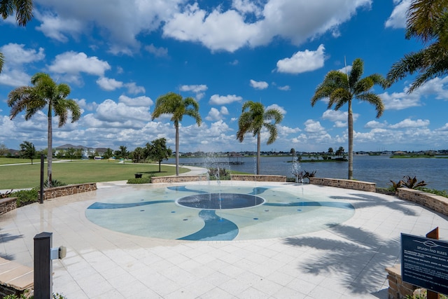 surrounding community featuring a water view and a lawn