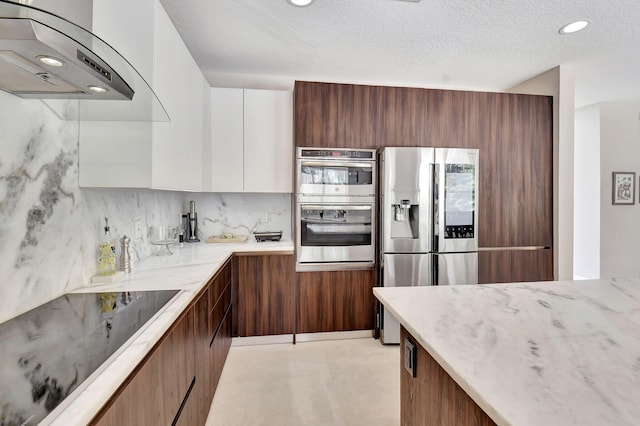 kitchen with stainless steel appliances, backsplash, ventilation hood, white cabinets, and a textured ceiling