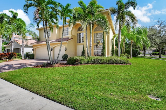 mediterranean / spanish-style house with a front yard and a garage