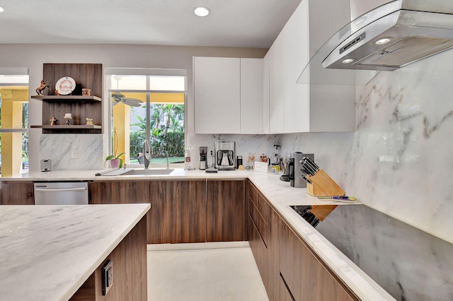 kitchen featuring wall chimney exhaust hood, dishwasher, white cabinets, and decorative backsplash