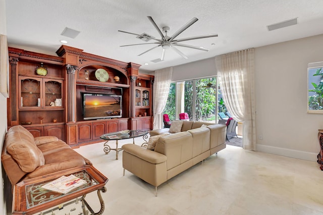 living room featuring a textured ceiling and ceiling fan