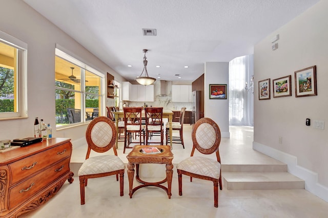 dining space featuring a textured ceiling