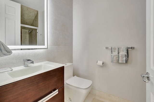 bathroom featuring backsplash, vanity, toilet, and walk in shower