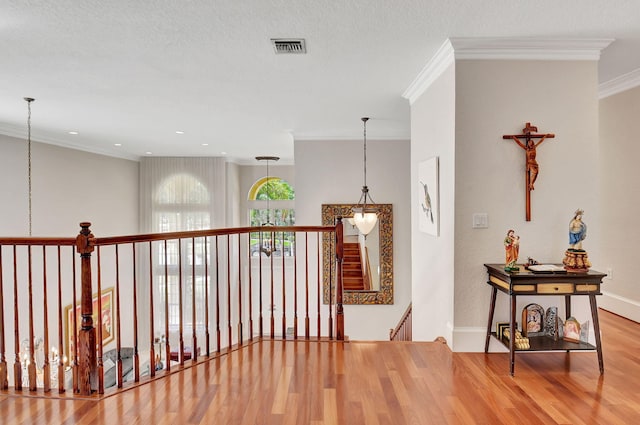 corridor featuring ornamental molding and wood-type flooring