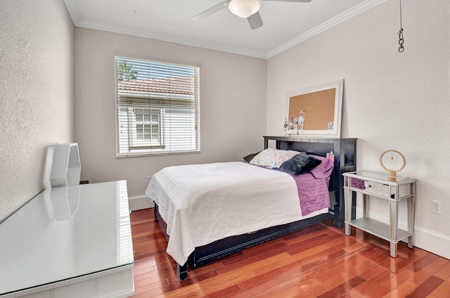 bedroom featuring ornamental molding, hardwood / wood-style flooring, and ceiling fan