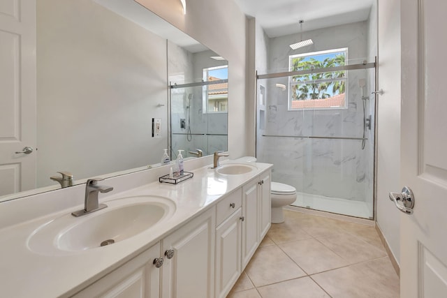 bathroom with vanity, toilet, tile patterned flooring, and an enclosed shower