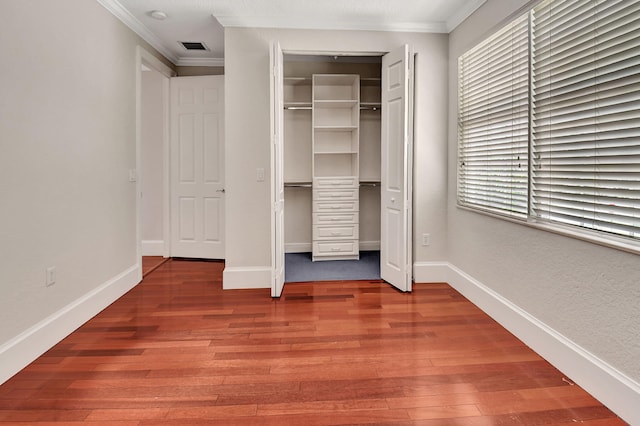 interior space with crown molding and hardwood / wood-style flooring