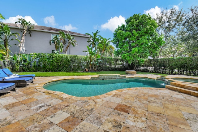 view of swimming pool featuring an in ground hot tub, a patio, and a yard