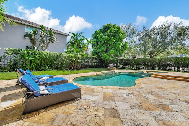 view of swimming pool featuring a patio area and an in ground hot tub