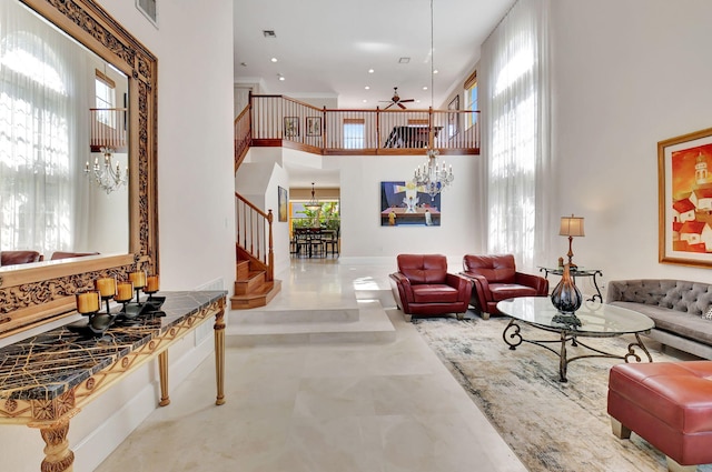 living room featuring concrete floors, a high ceiling, plenty of natural light, and ceiling fan