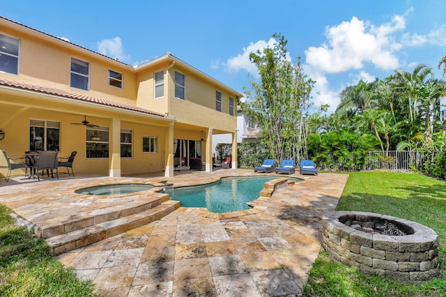 view of pool with an in ground hot tub, an outdoor fire pit, a patio area, and ceiling fan