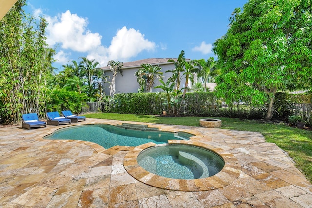 view of pool featuring a patio area and an in ground hot tub