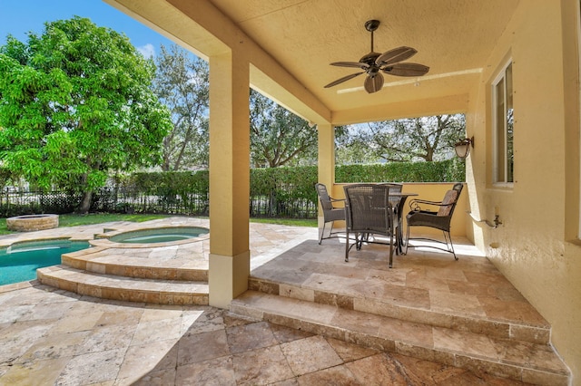 view of patio / terrace featuring ceiling fan and a swimming pool with hot tub