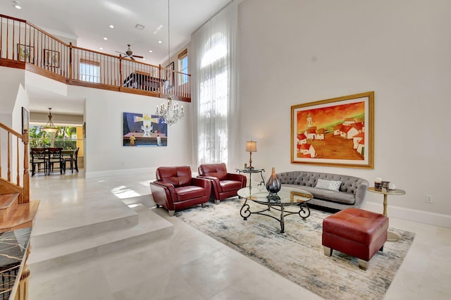 living room with ceiling fan and a high ceiling