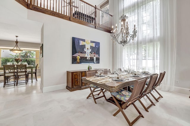 dining room with an inviting chandelier and a high ceiling