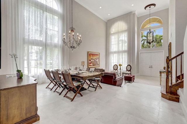 dining space featuring a chandelier and a high ceiling