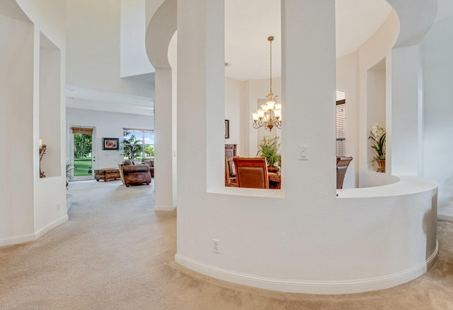 interior space featuring carpet floors and an inviting chandelier