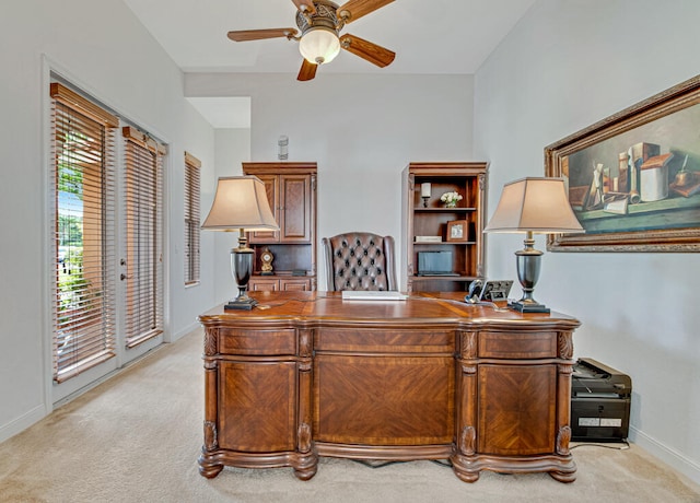 home office featuring ceiling fan and light carpet