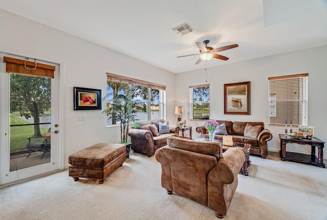 carpeted living room featuring ceiling fan